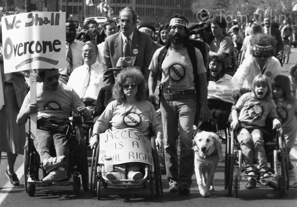 A historical black and white photograph of a disability rights protest.